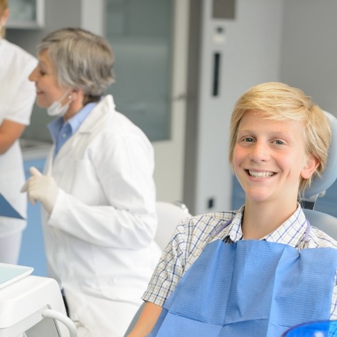 Child smiling in dental treatment chair