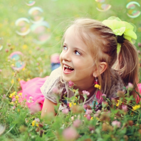 Child outdoors smiling