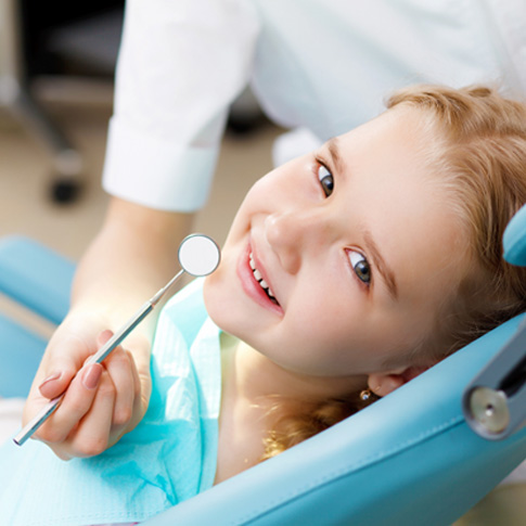 Girl having her teeth checked at the dentist’s 