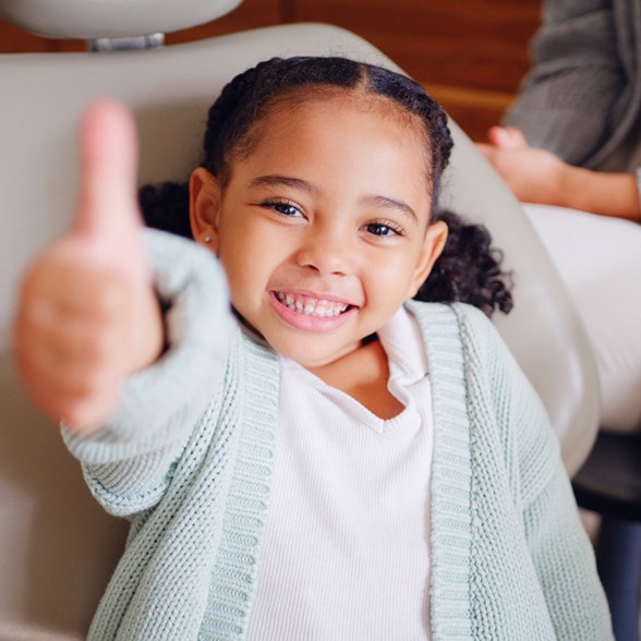 a child at the dentist smiling 