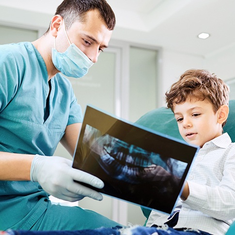 Dentist reviewing X-ray with patient