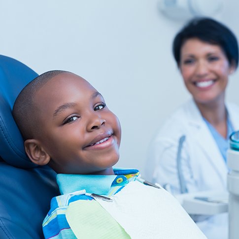 Smiling child and dentist at appointment