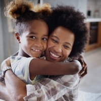 Mother hugging daughter