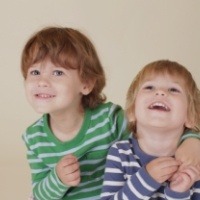 Two young children smiling