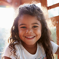 Young girl smiling outdoors