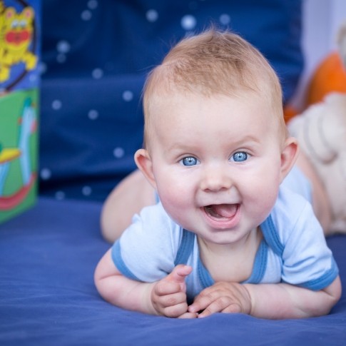 Baby smiling after receiving dentistry for infants