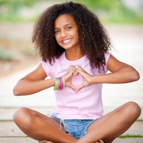 Young girl smiling after dentistry for children visit