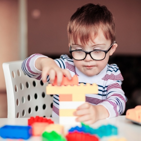 Child playing with blocks after special needs dentistry visit