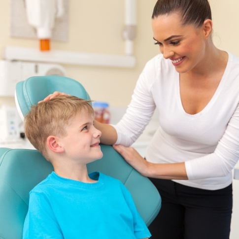 Child smiling during dental checkup and teeth cleaning visit