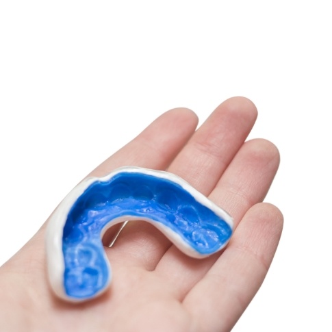 Person holding a custom athletic mouthguard