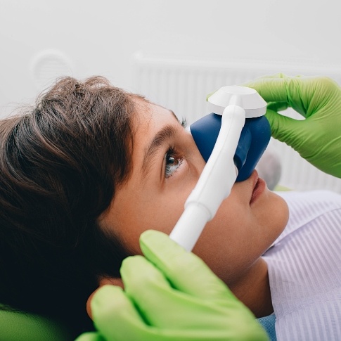Child receiving nitrous oxide dental sedation treatment