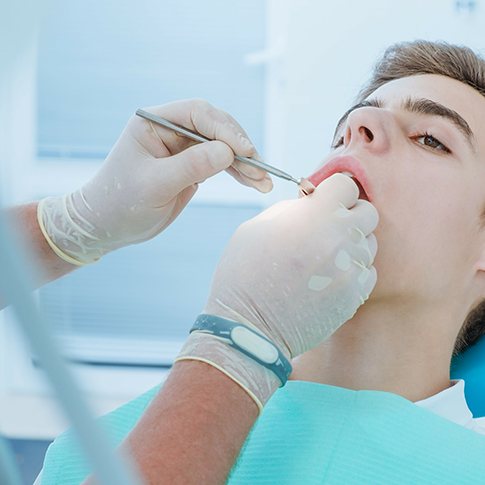a teen receiving urgent dental treatment