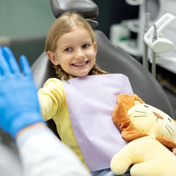 Child high-fiving her dentist
