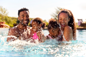 a family playing in a swimming pool 