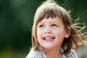 a closeup of a child smiling