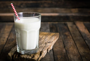 a glass of milk with a straw