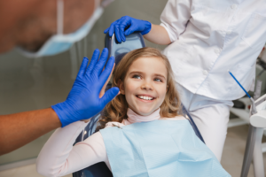 a child high-fiving their dentist