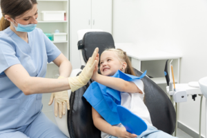 a child smiling during a dental appointment