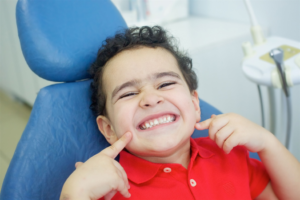 a child smiling during a dental appointment