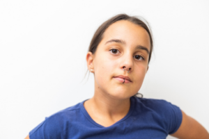 a teen with a pierced lip