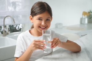 a child drinking a glass of water
