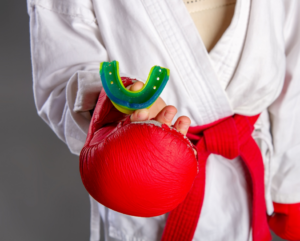 a child holding their athletic mouthguard