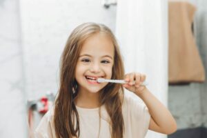 Special needs child brushing her teeth 